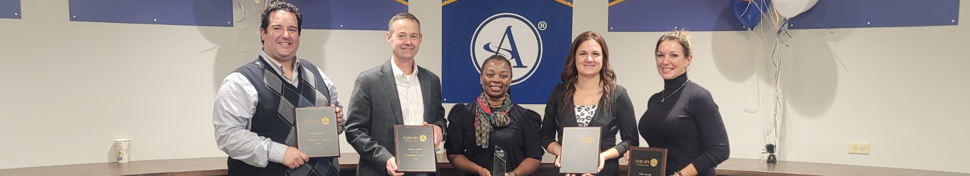 Four associates holding their 2023 special recognition awards